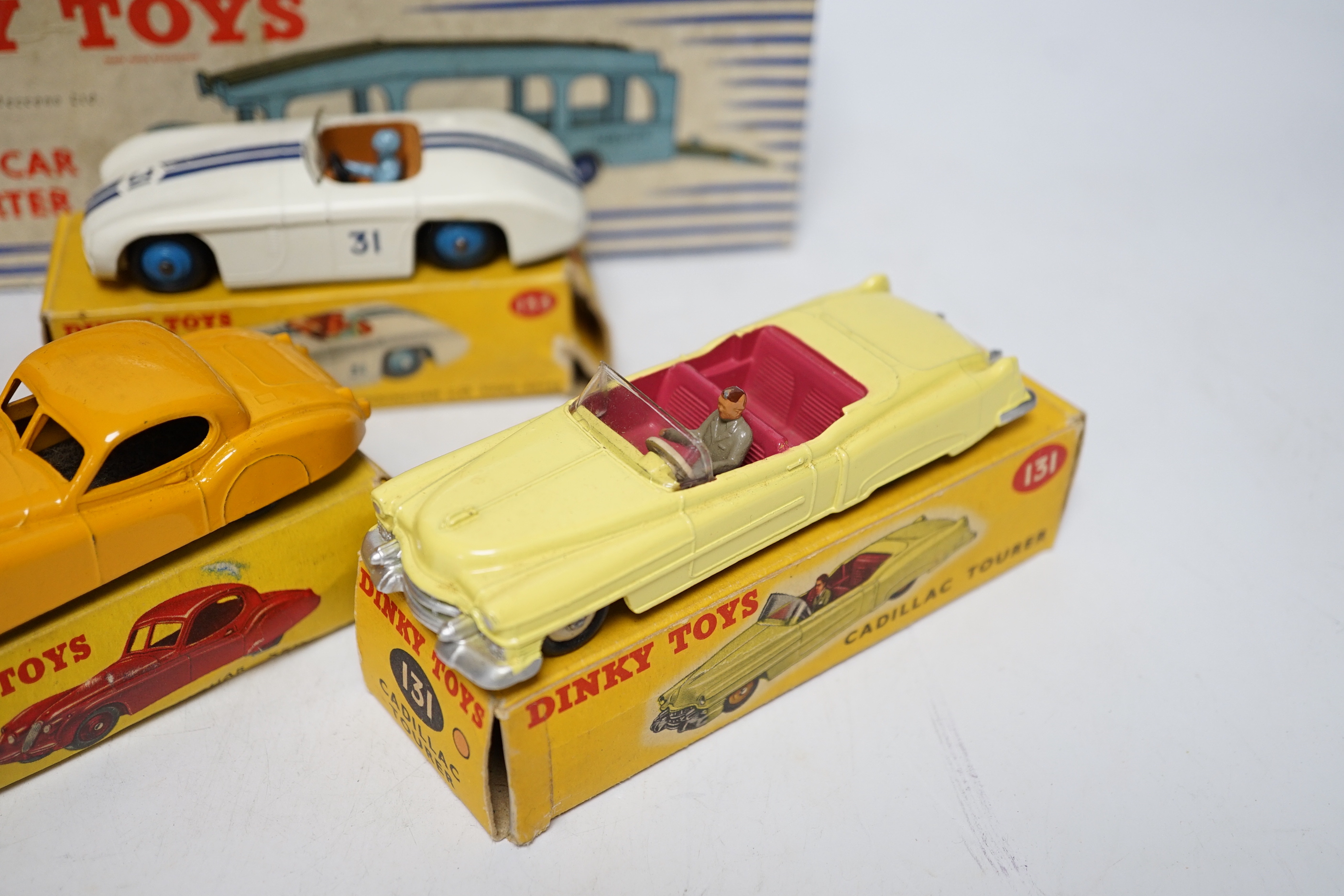 Five boxed Dinky Toys; (132) a Packard Convertible, (131) a Cadillac Tourer, (133) a Cunningham C-5R road racer, (157) a Jaguar XK120 and (582) a Pullmore Car Transporter with a (994) Loading Ramp, together with a Cresce